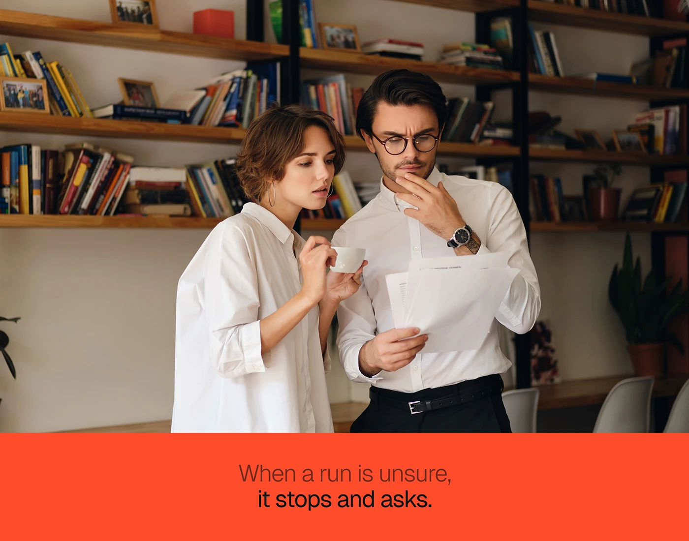 Two colleagues checking a printed document under the line when a run is unsure, it stops and asks